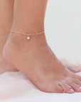 model wearing dainty ankle bracelet by chokha india which is gold plated  